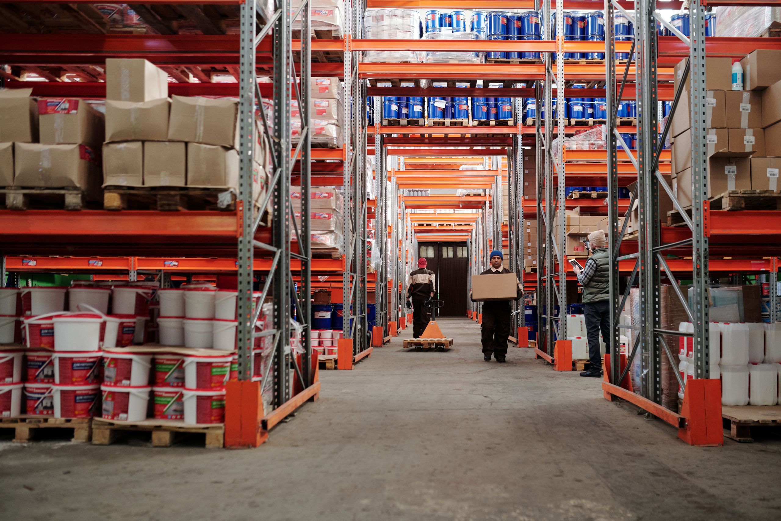 Representative warehouse photograph with stocked shelves and cartons; not a company facility